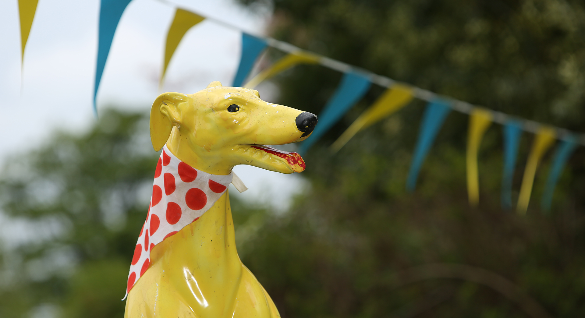 Dog statue with polkadot neck scarf